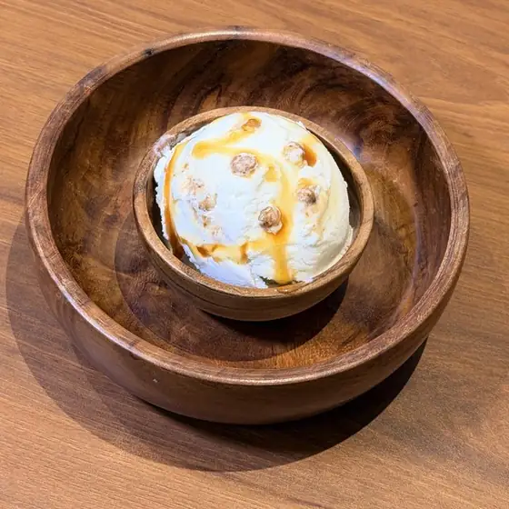 Butterscotch ice cream in a wooden bowl