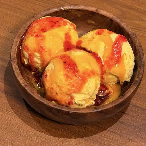 Mango Raspberry sundae in a wooden bowl